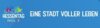Das Bild zeigt das Logo für den Hessentag in Fritzlar. Auf blauem Hintergrund steht in weißen Großbuchstaben Hessentag Fritzlar, eine Stadt voller Leben. Links mittig sind einige Häuser umrissen und darüber mehrere Menschen in verschiedenen Farben ausgemalt zu sehen.