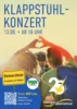Veranstaltungsplakat zum Klappstuhlkonzert am 13. August 2026 auf der Festwiese am Ommersheimer Weiher. Zu sehen sind zwei Menschen in Klappstühlen, die mit ihren Händen ein Herz formen. Es spielen MEP-Live, die Moderation übernimmt Michael Friemel. Der Eintritt ist frei.  Quelle: Energie SaarLorLux