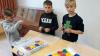 2 Sch&uuml;ler helfen einem zuk&uuml;nftigen Erstkl&auml;ssler beim Bauen